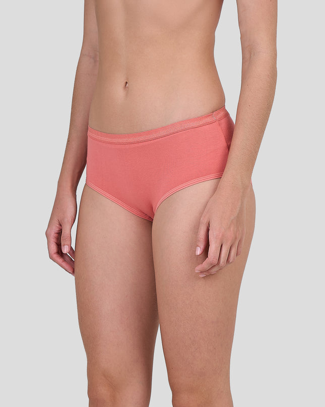 Person wearing a Dice coral pink bikini bottom on a light gray background