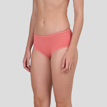 Person wearing a Dice coral pink bikini bottom on a light gray background