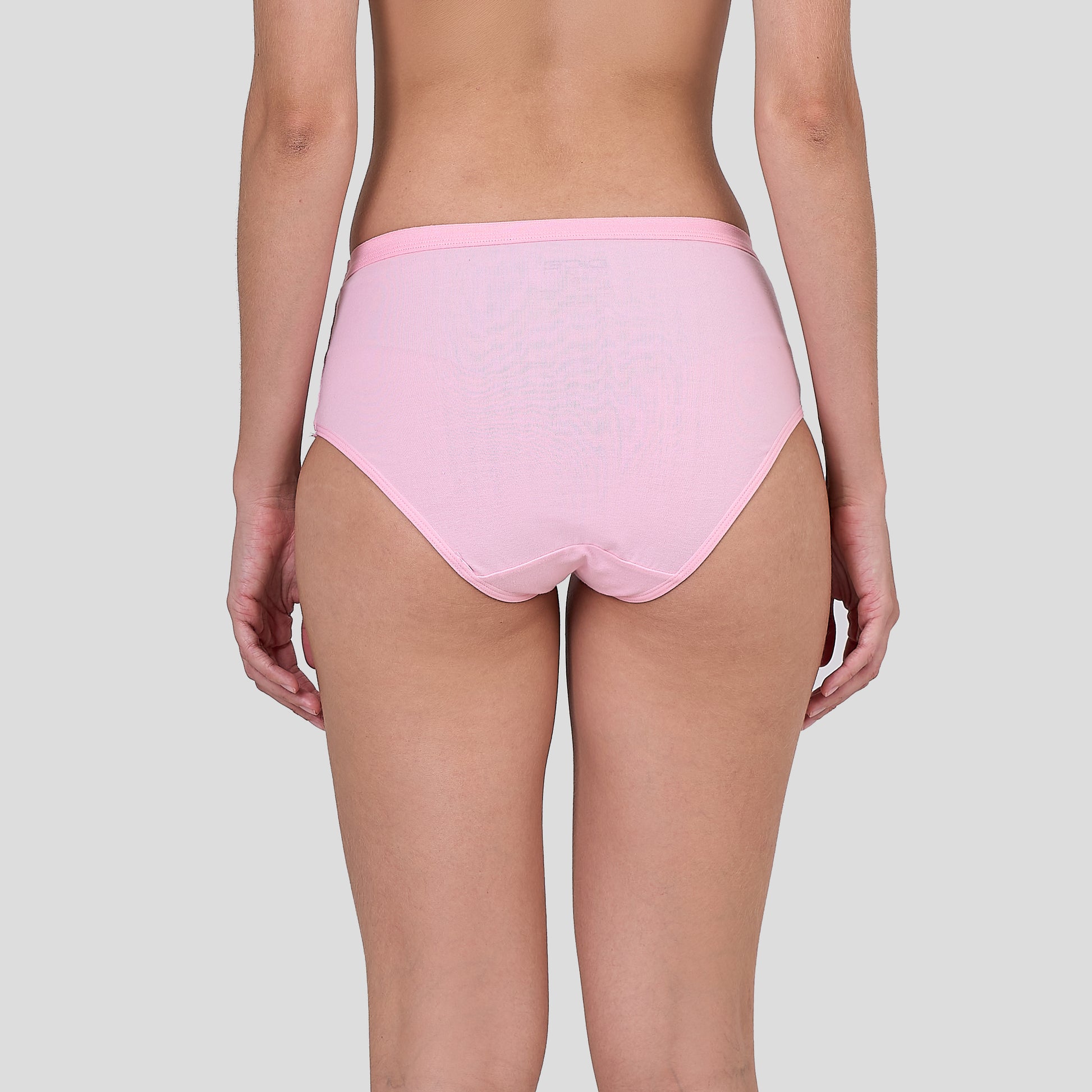 Person wearing a Dice pink high-waisted underwear on a plain background