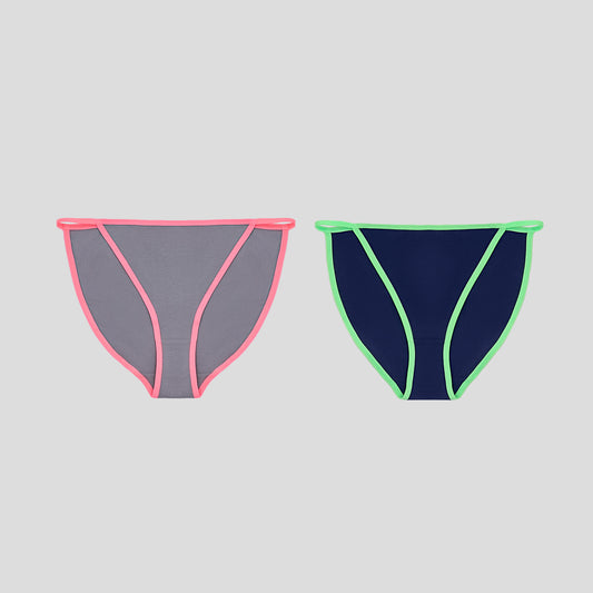 Two Dice bikini bottoms with pink and green trim on a gray background