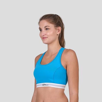 Woman wearing a Dice blue sports bra and white underwear on a light gray background