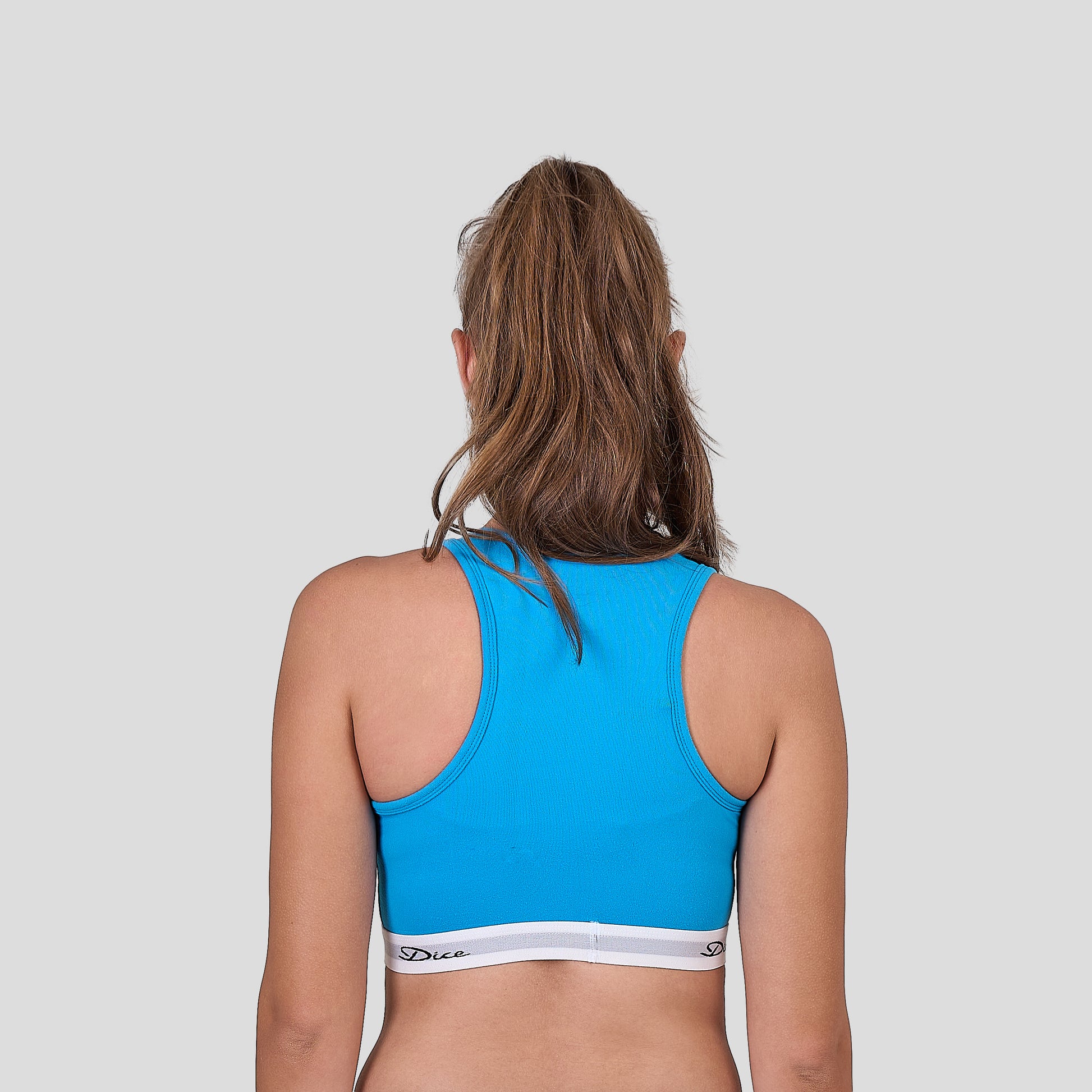 Dice blue sports bra on a plain background