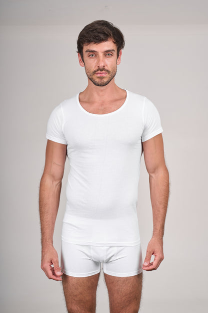 Man wearing a plain white t-shirt and underwear set against a neutral background
