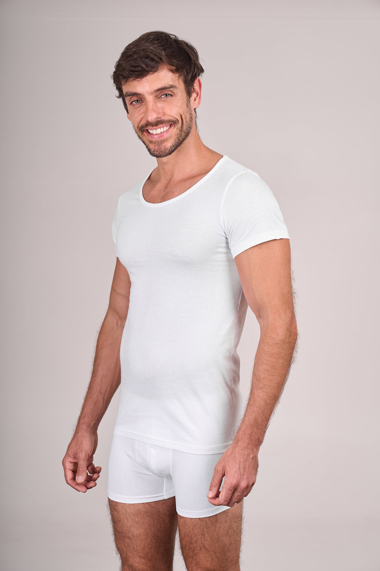 Man wearing Dice white t-shirt and shorts on a plain background