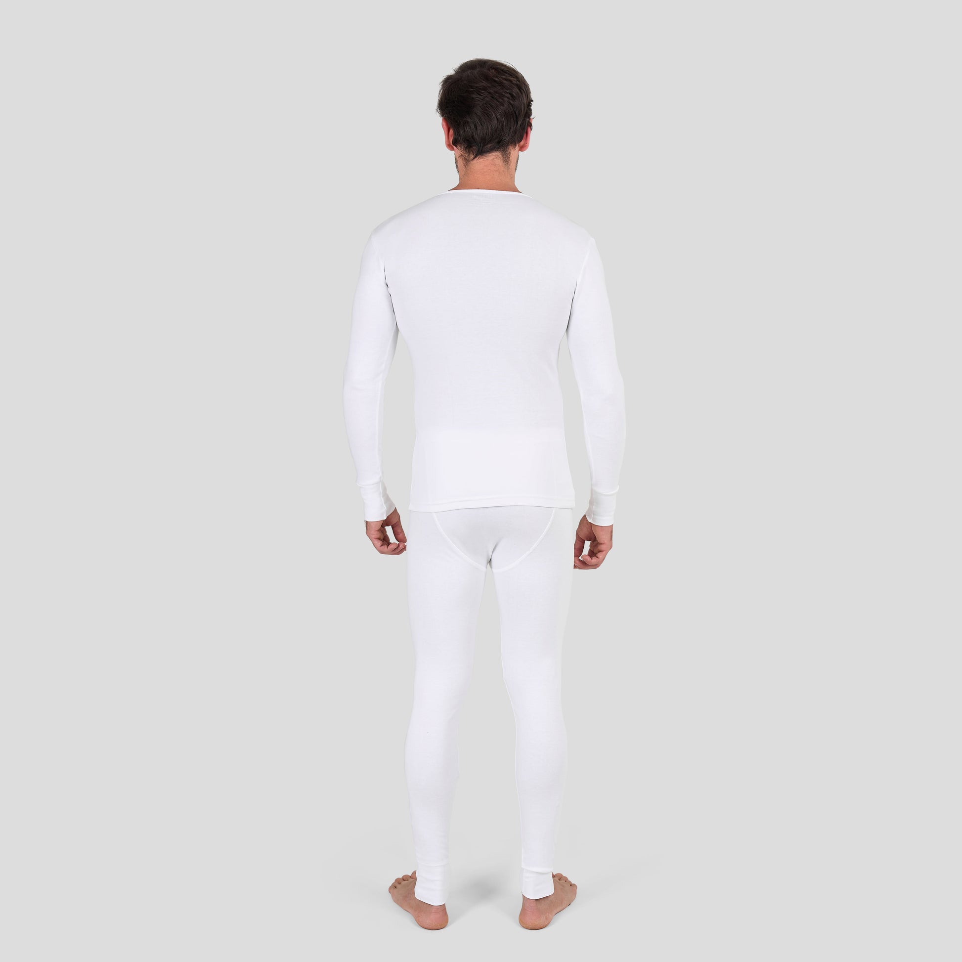 Man wearing Dice white long-sleeve shirt and pants on a light gray background