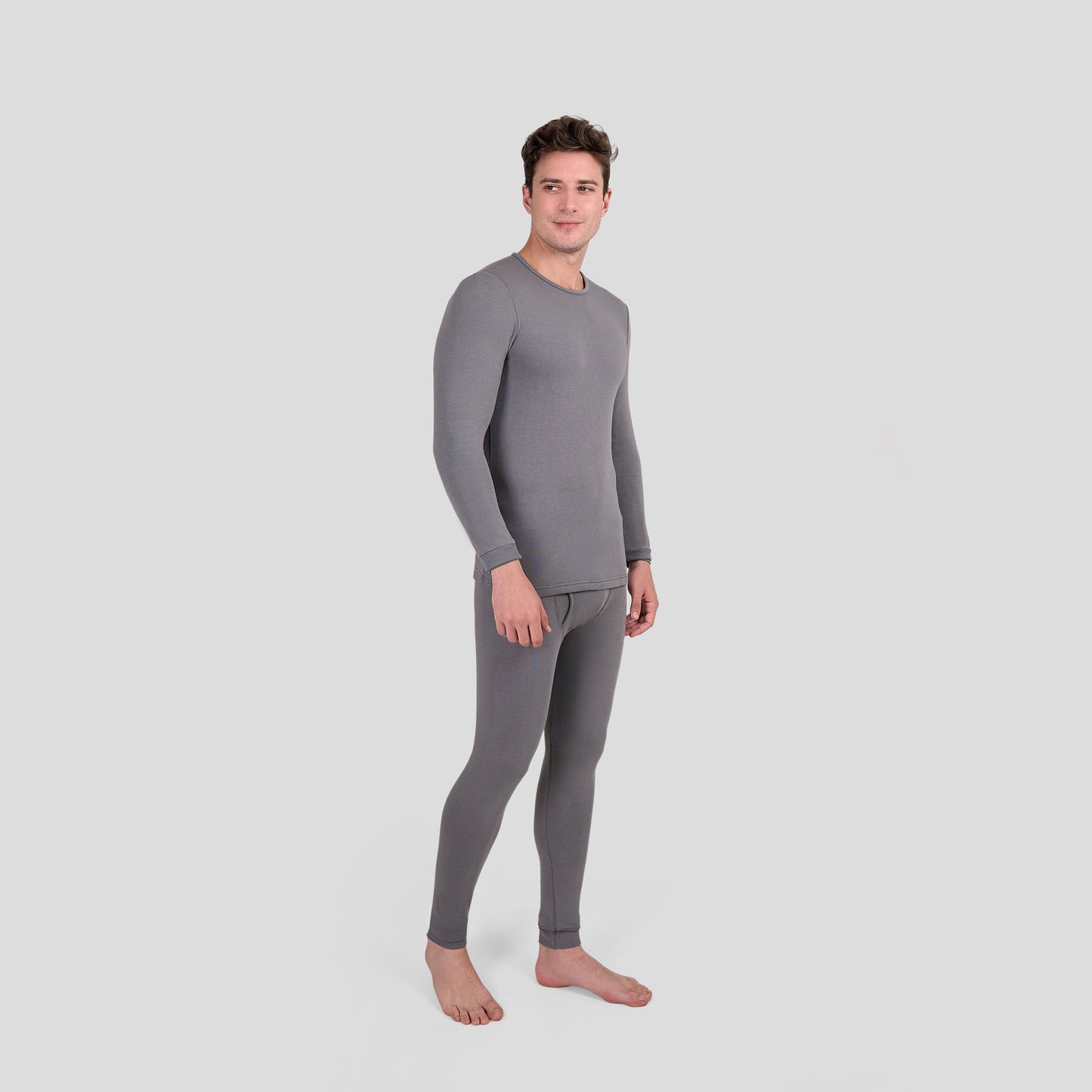 Man wearing a gray thermal Dice underwear set on a light gray background