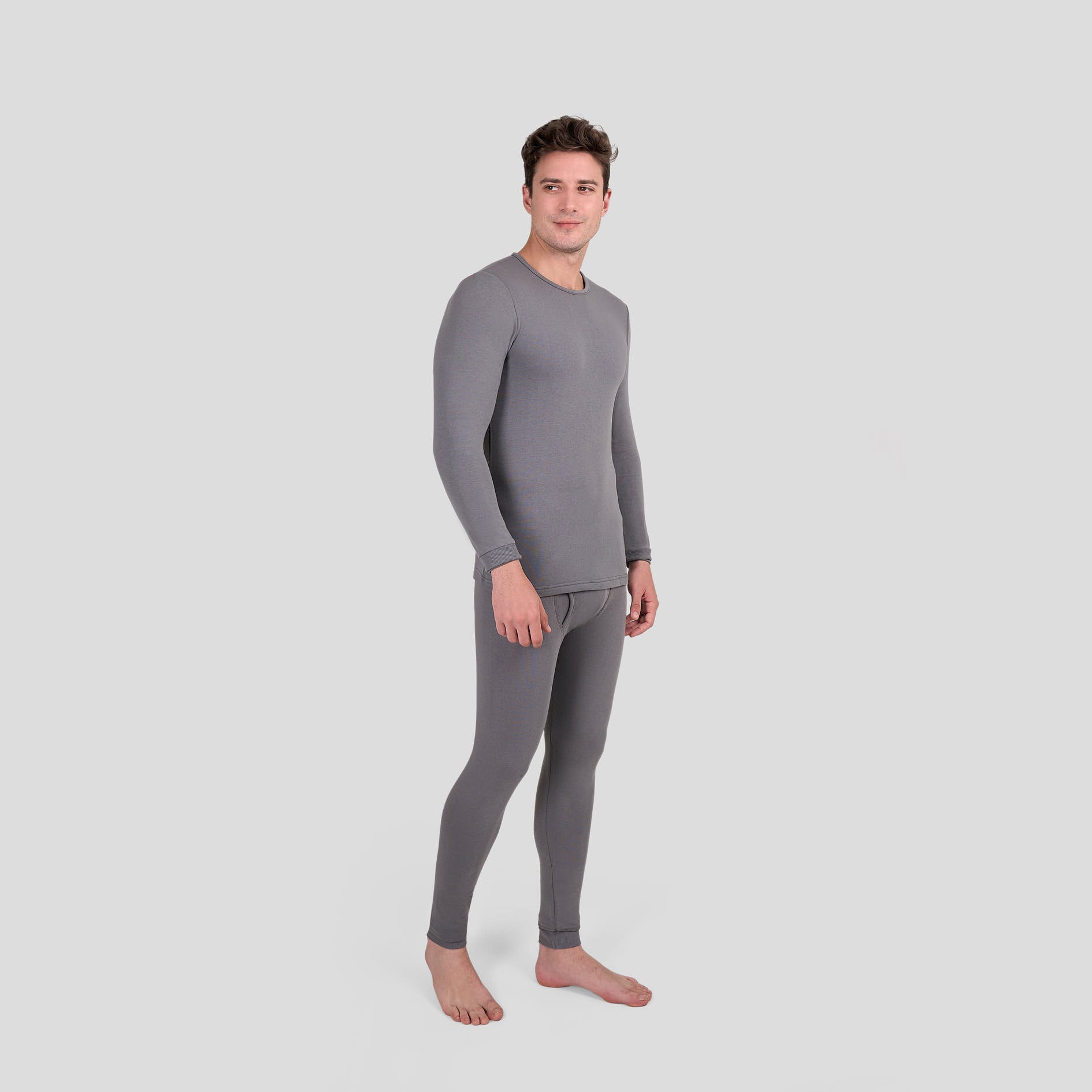 Man wearing a gray thermal Dice underwear set on a light gray background